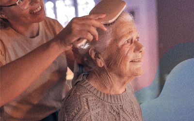 Woman brushing elder relative's hair